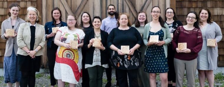 A group of people holding awards